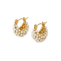 Gold plated huggies with pearl accents by NIYANSA