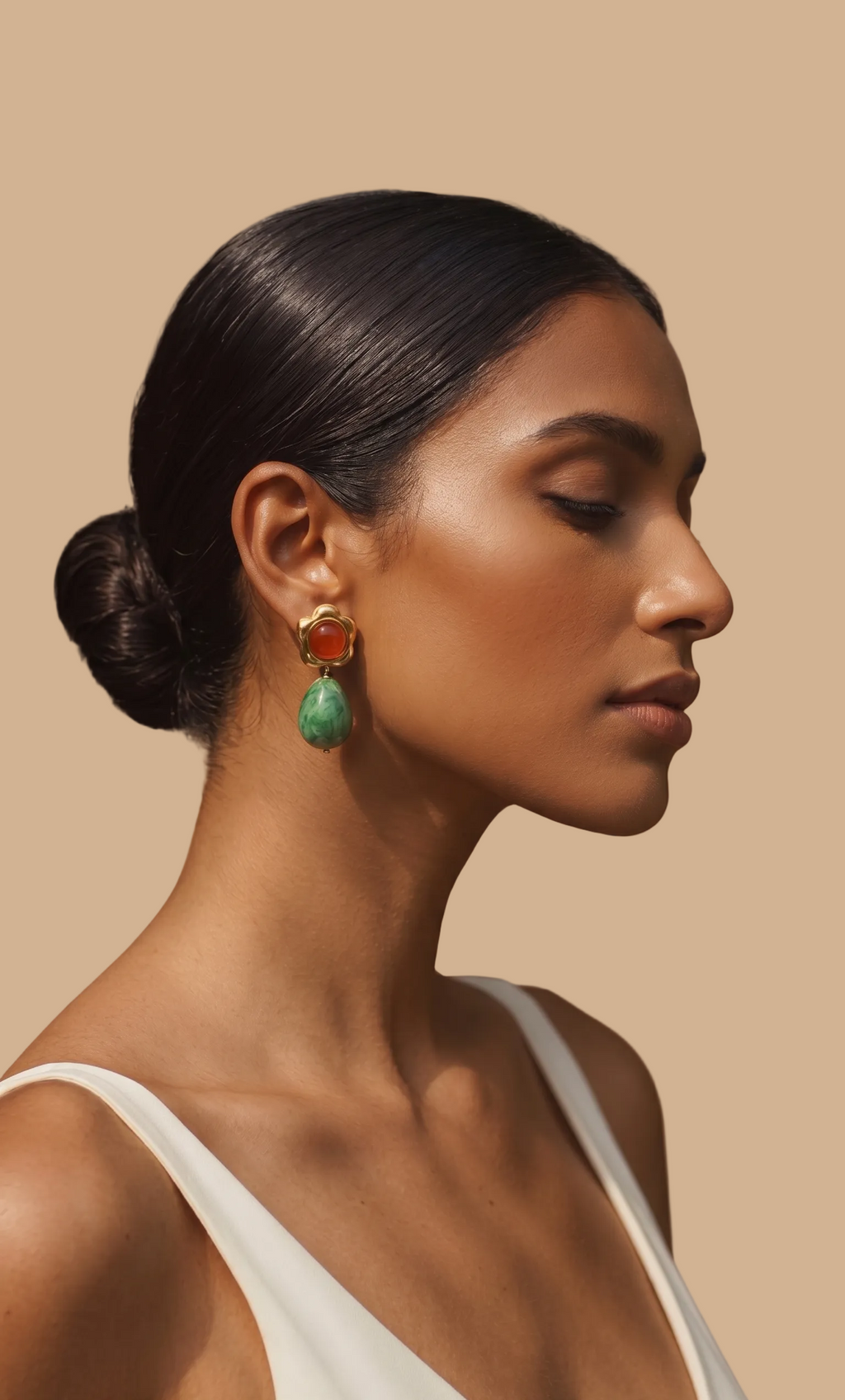 Woman wearing colorful earrings against a beige background