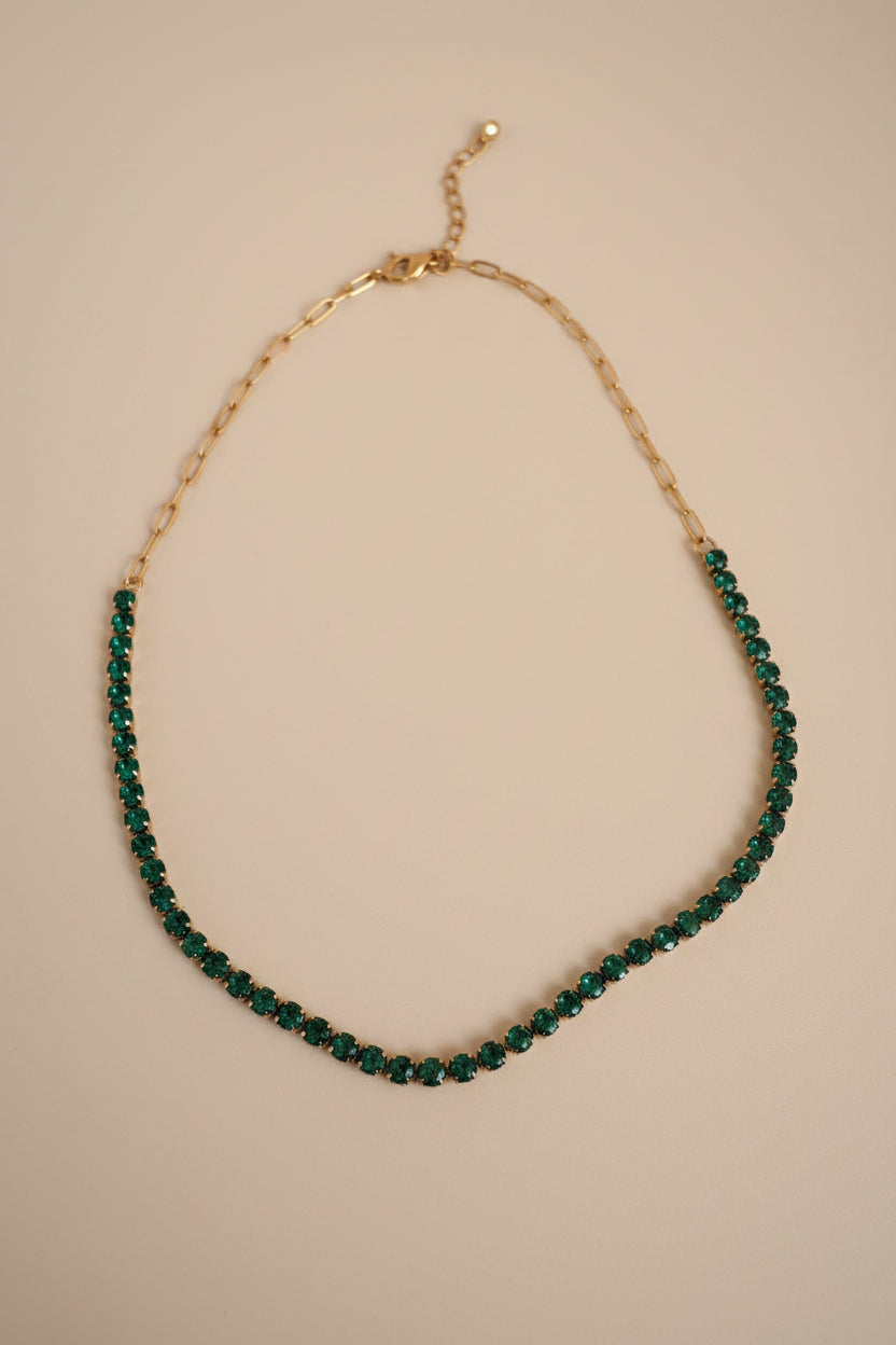 The NIYANSA green tennis necklace with vibrant stone detailing in 18KT PVD gold-plated stainless steel.