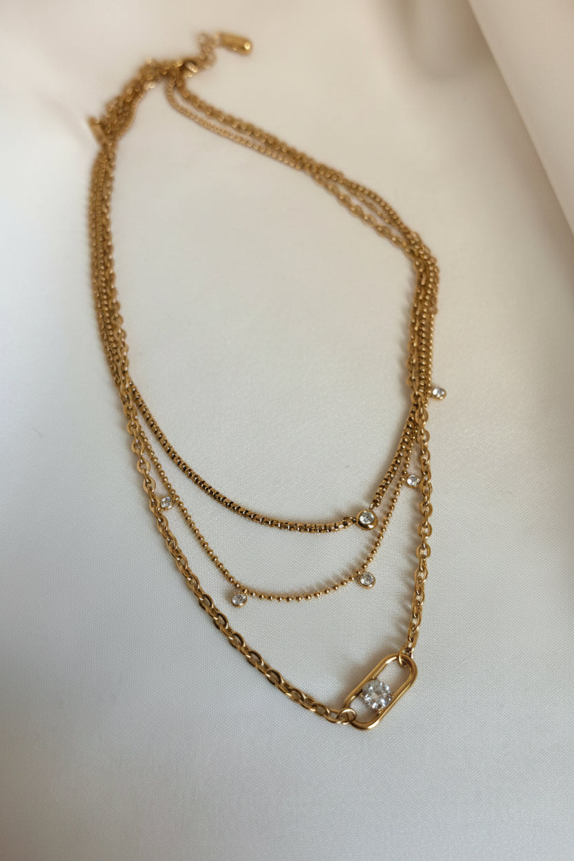 Layered gold chain necklace with AAA cubic zirconia accents and statement clasp detail by NIYANSA.