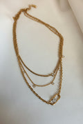 Layered gold chain necklace with AAA cubic zirconia accents and statement clasp detail by NIYANSA.