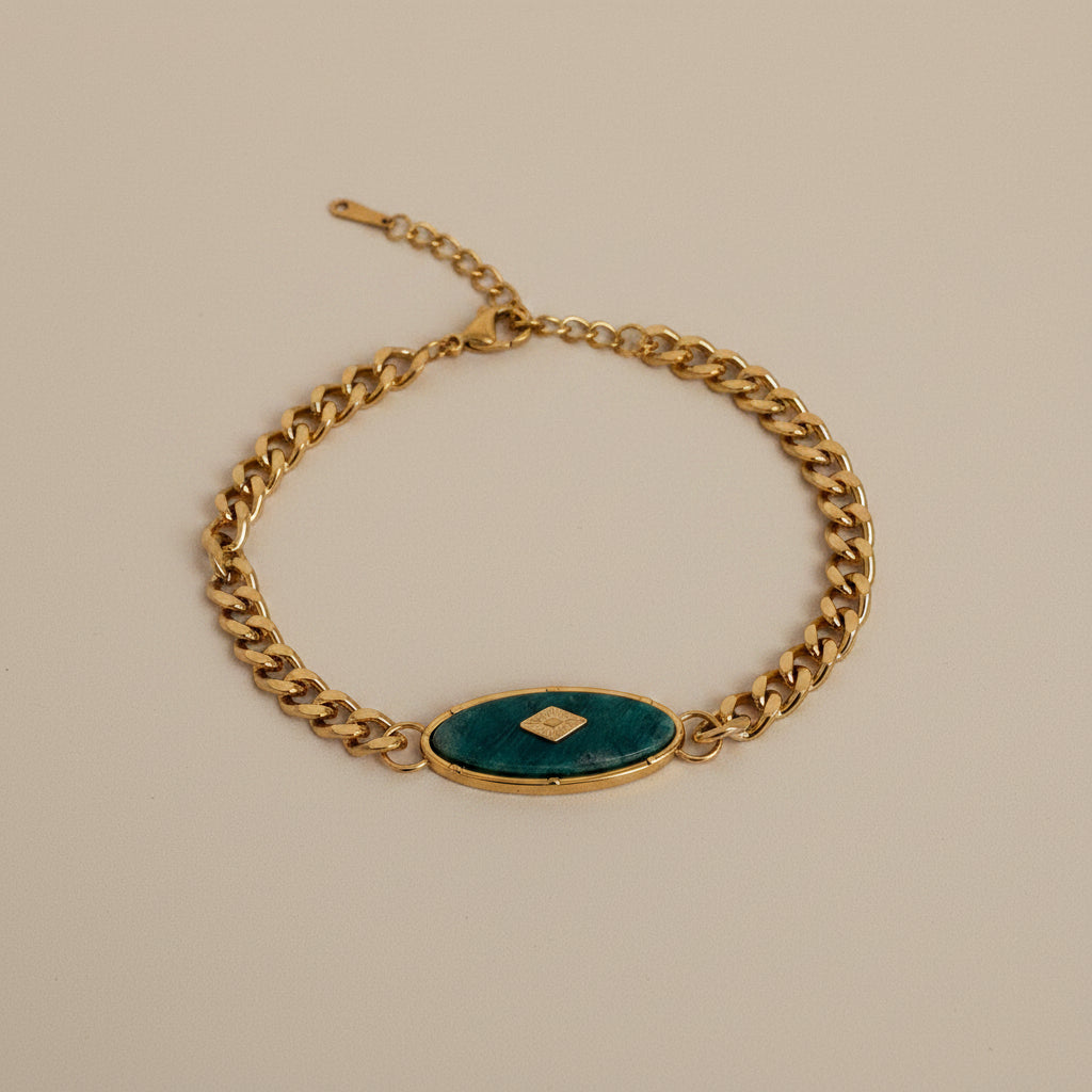 18kt pvd plated gold bracelet with a natural green stone in the center. 