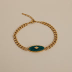 18kt pvd plated gold bracelet with a natural green stone in the center. 