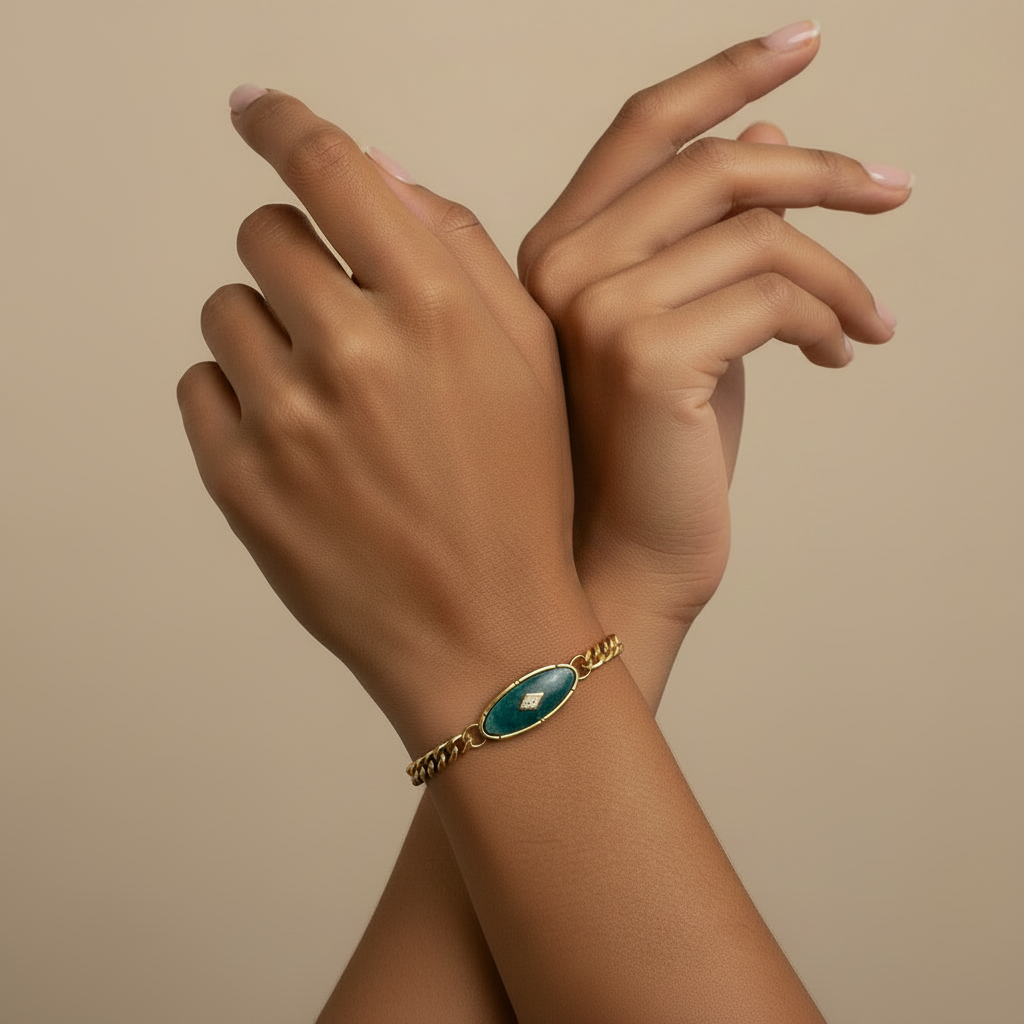 18kt pvd plated gold bracelet with a natural green stone in the center. 