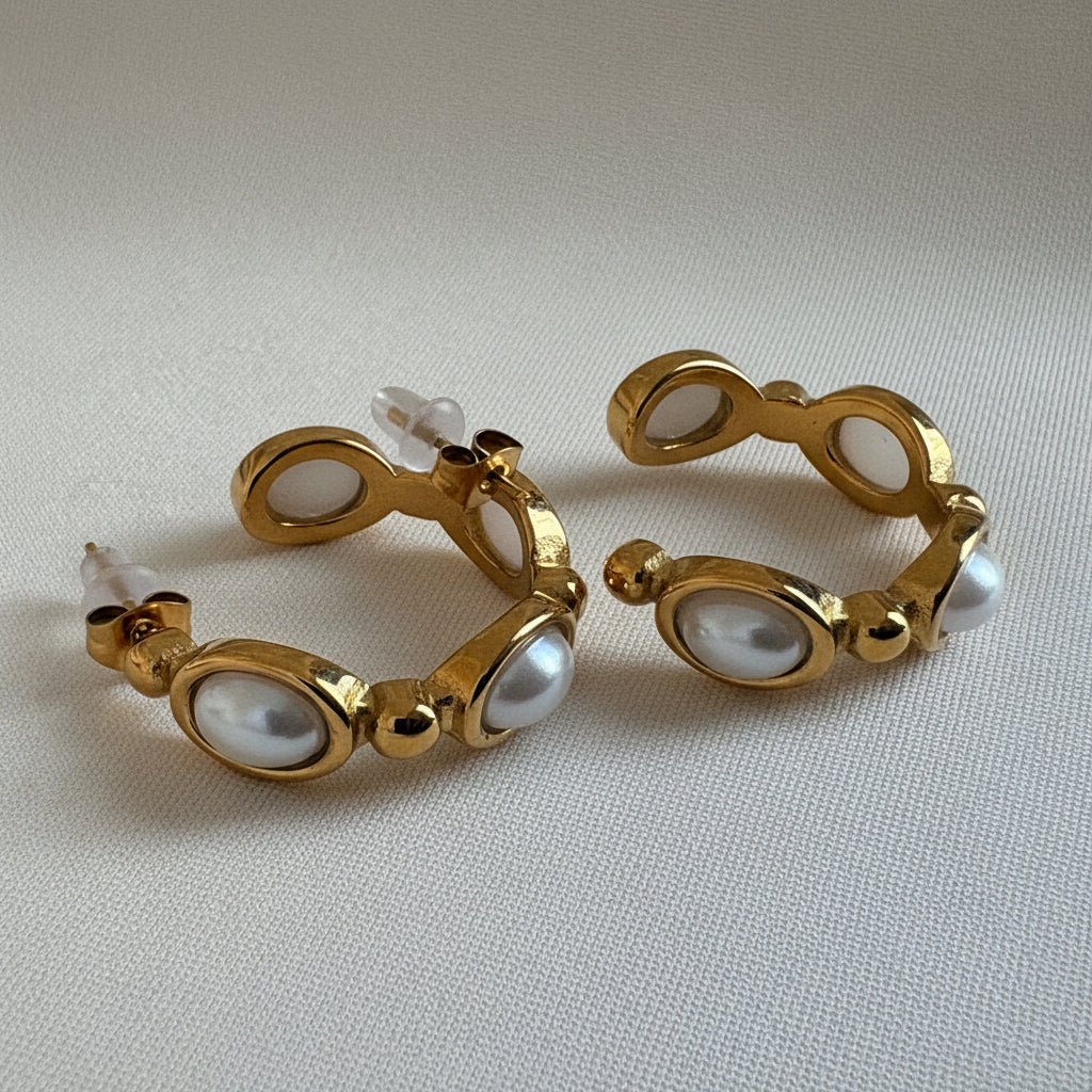 Freshwater pearl hoop earrings in 18KT PVD gold-plated stainless steel with sculptural gold detailing by NIYANSA.