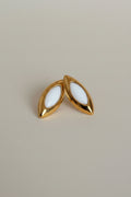 Marquise-shaped gold stud earrings with white enamel detailing by NIYANSA.