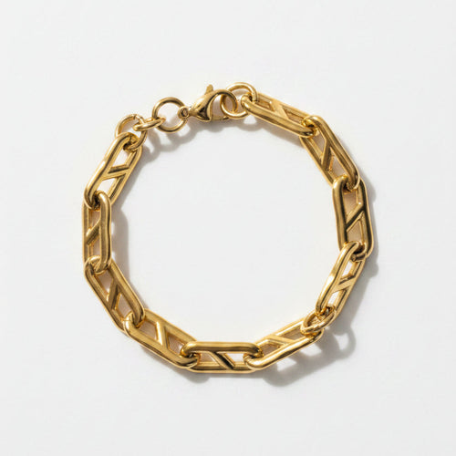 Gold chain bracelet on a light beige background