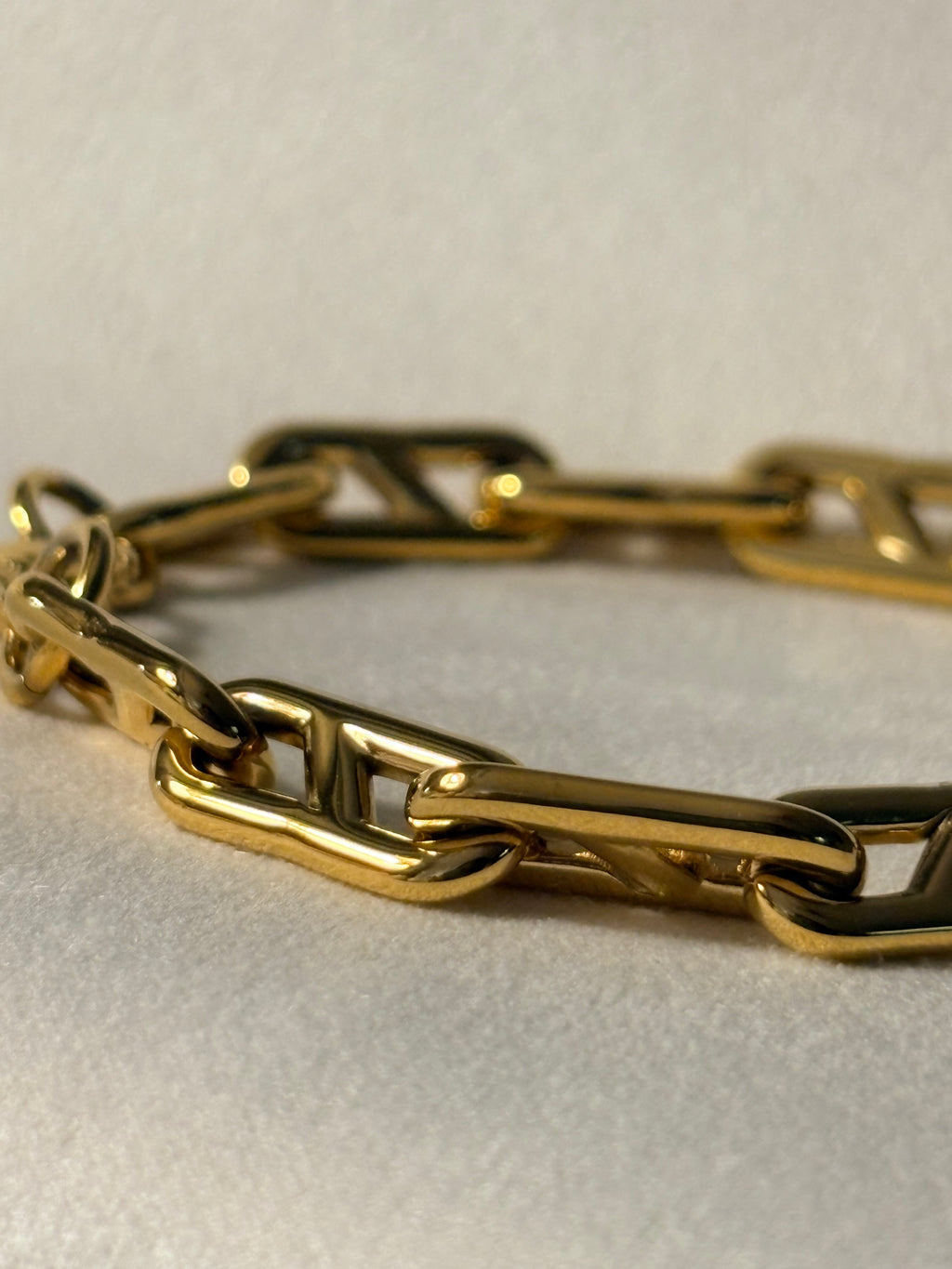 Gold chain on a light beige background