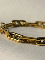 Gold chain on a light beige background