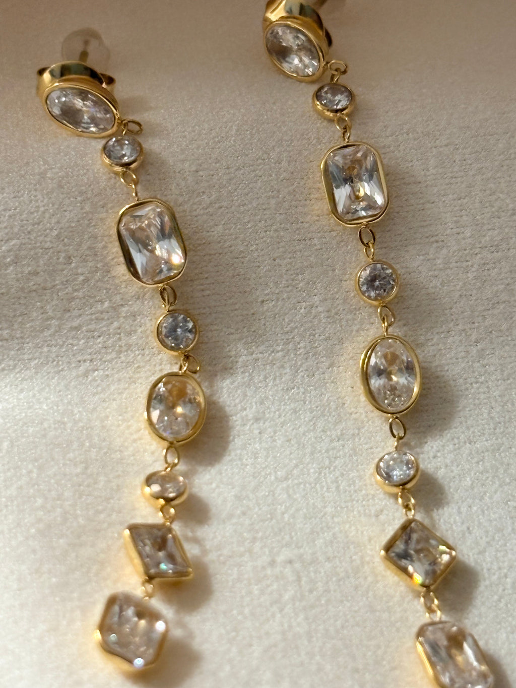 18KT gold plated crystal drop earrings with multi-shaped stones in waterproof anti tarnish finish by NIYANSA.