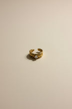 Adjustable gold ring with AAA cubic zirconia in 18KT PVD gold plated stainless steel.