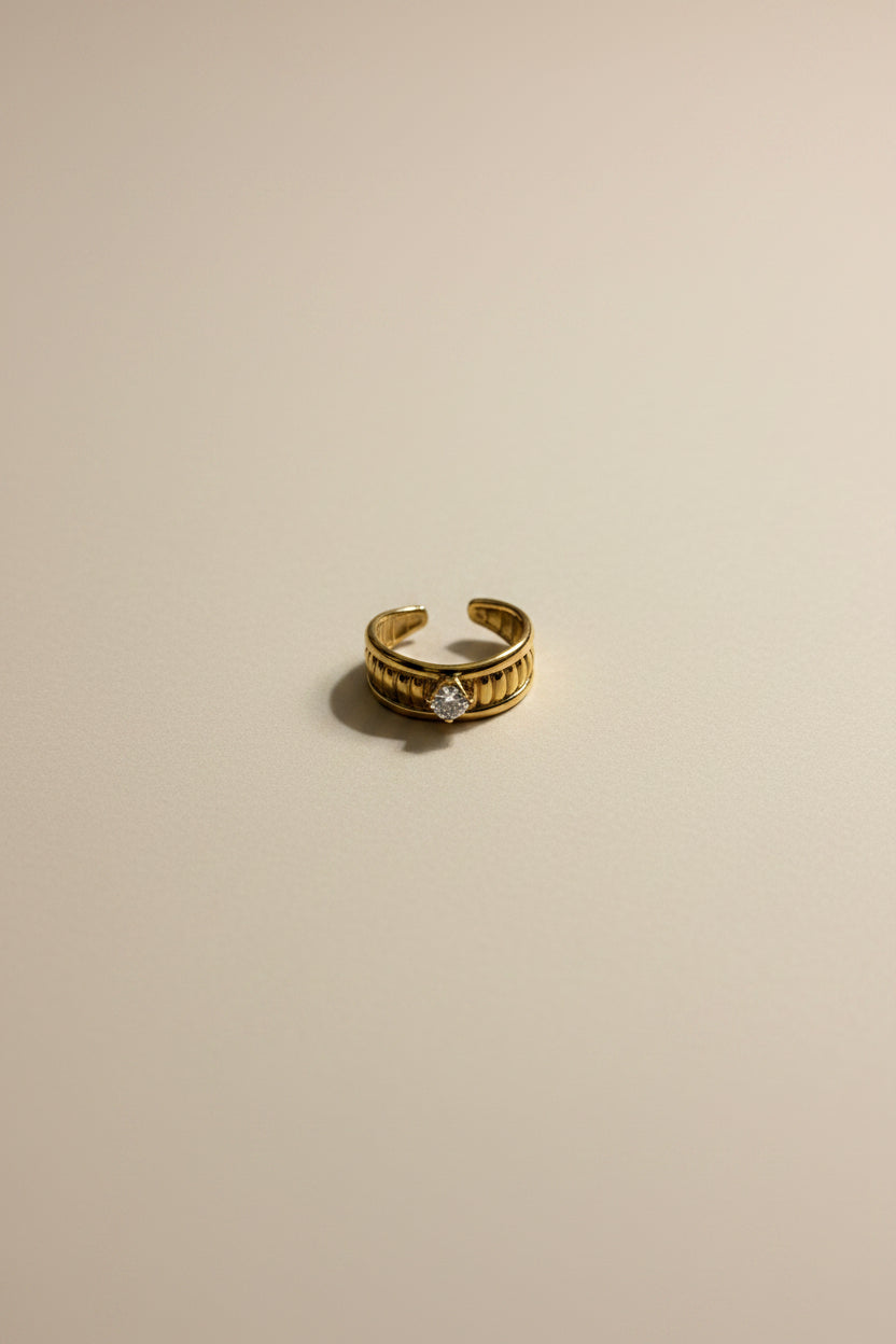 Adjustable gold ring with AAA cubic zirconia in 18KT PVD gold plated stainless steel.